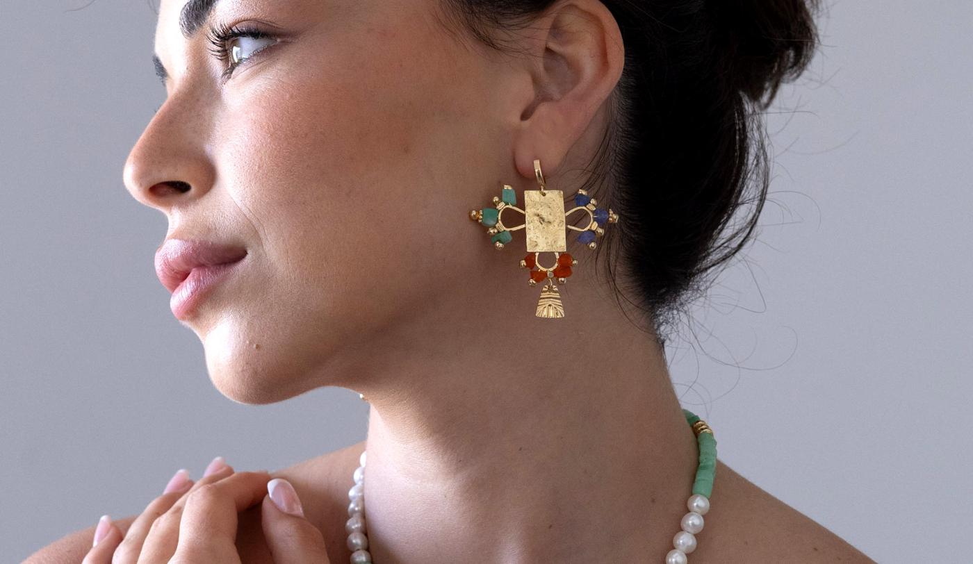 A gold birthstone earring and a pearl and gemstone necklace by Inbal Mishan
