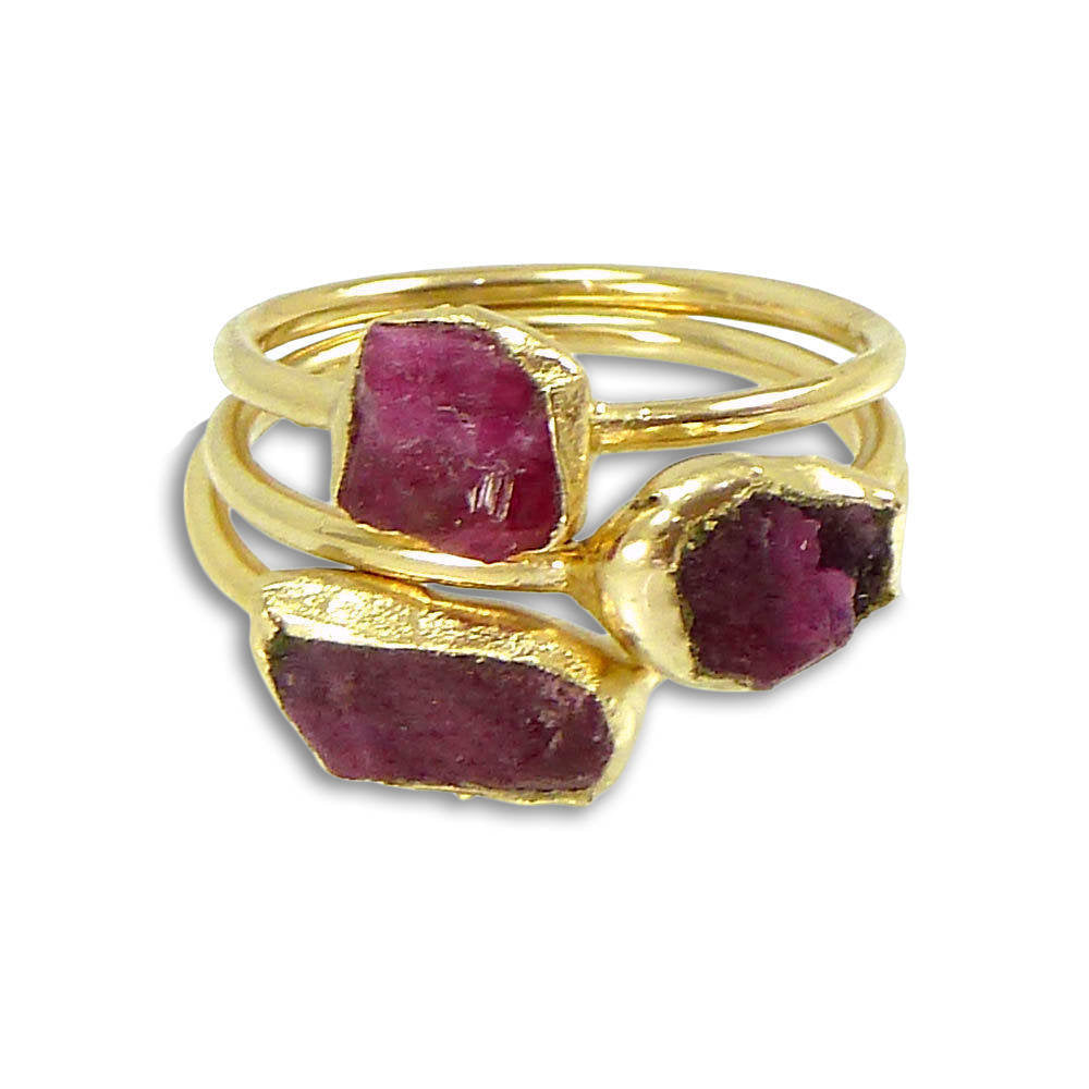 Premium Photo | Gold ring with a ruby stone and diamonds on women's hands